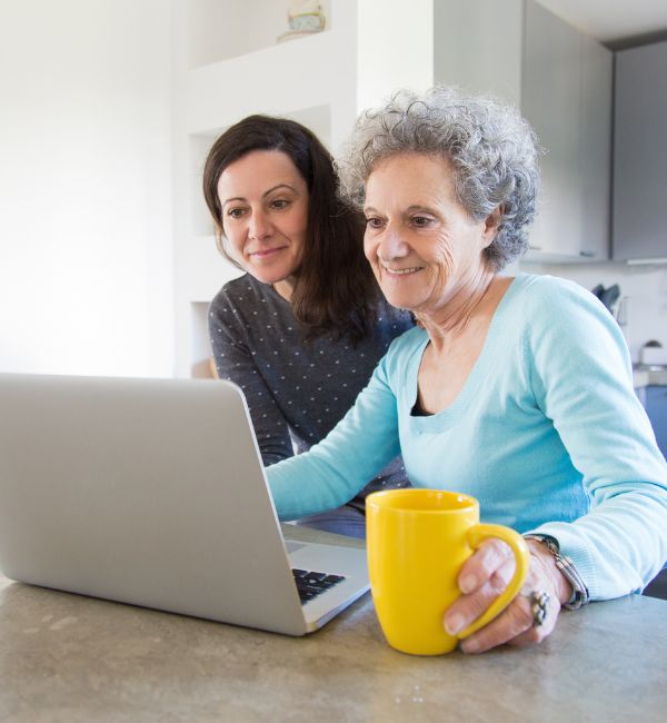 Senior woman with daughter reviewing Power of Attorney documents online