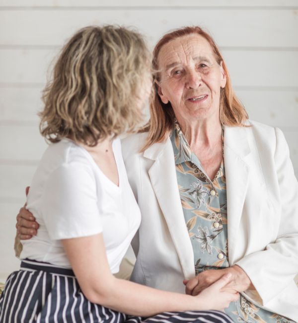 Senior woman with granddaughter discussing family matters and writing a will