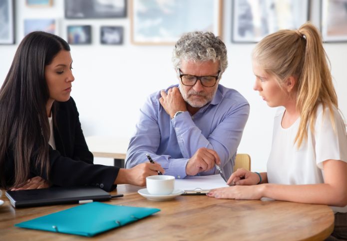 Lawyer advising family members on contesting a will during legal consultation