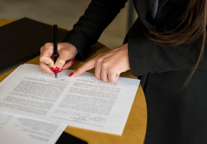 Power of attorney lawyer assisting client with signing legal documents