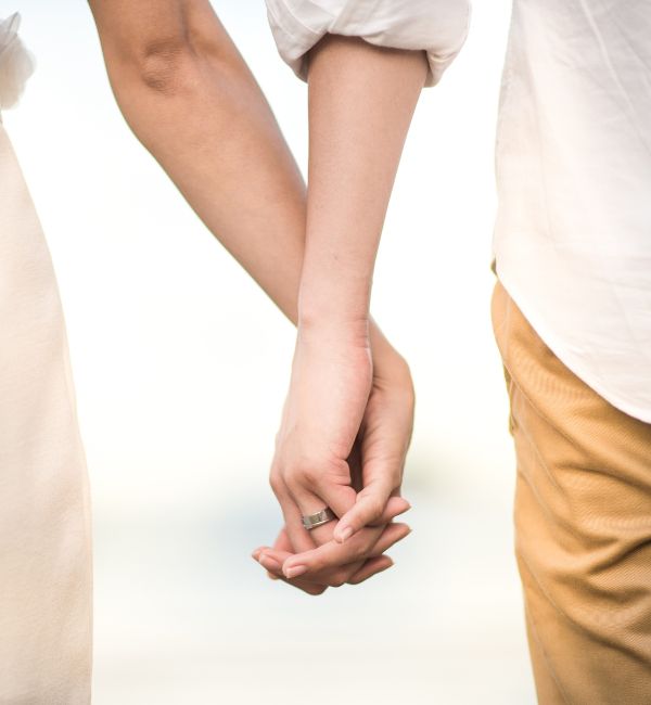 Couple holding hands symbolising support and unity after a de facto relationship separation.