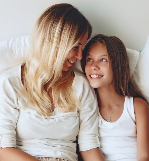Mother and daughter smiling together while preparing a guardianship application for future care.