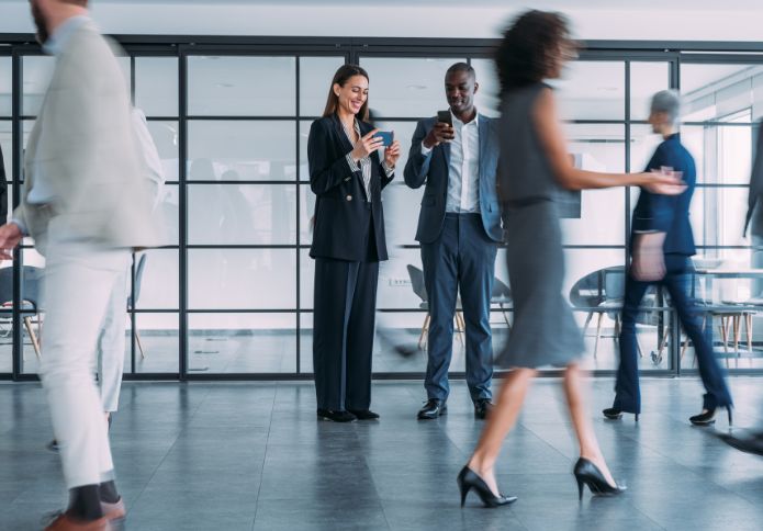 Business professionals in office discussing workplace rights – Adverse Action Claim support.