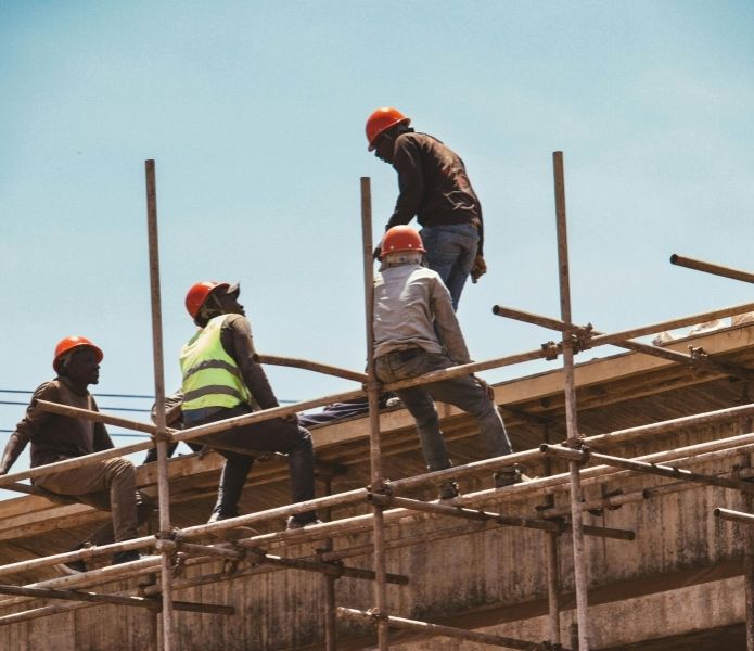 Construction workers wearing safety gear representing workplace injury cases handled by workers compensation lawyers